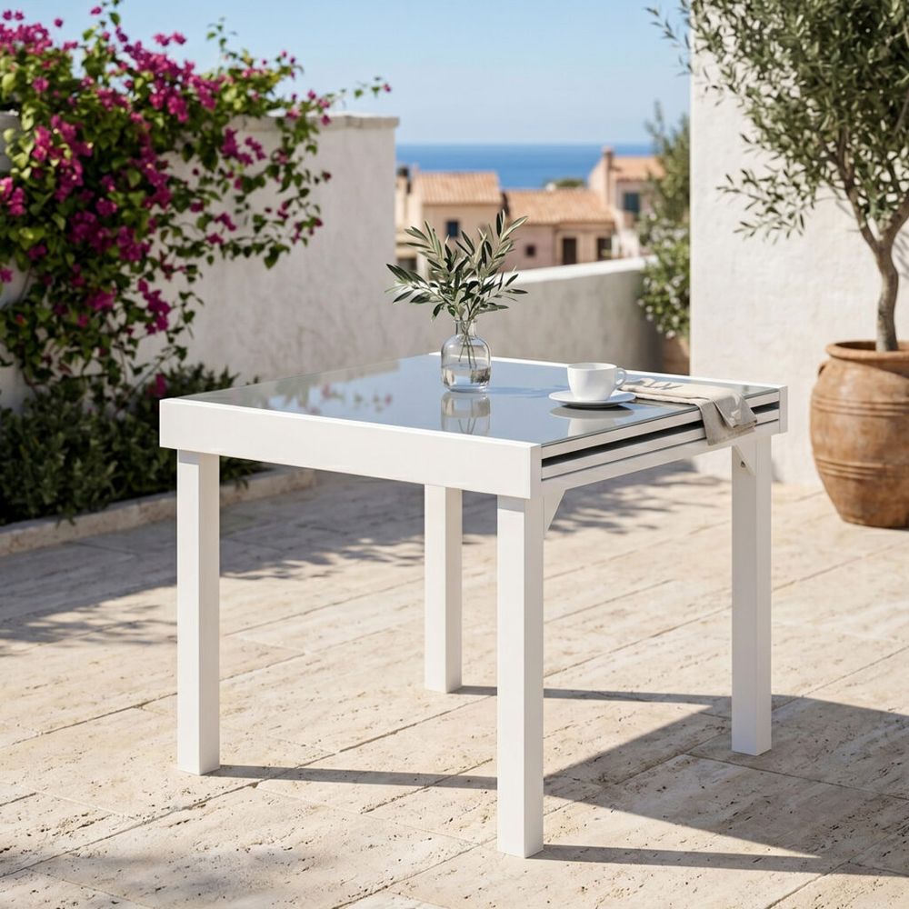 Table modulo 4/8 personnes structure en aluminium blanche. Plateau en verre coloris gris perle