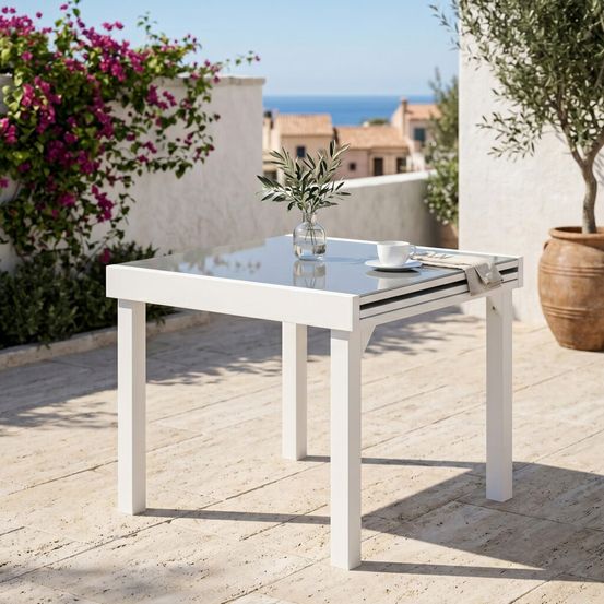 Table modulo 4/8 personnes structure en aluminium blanche. Plateau en verre coloris gris perle