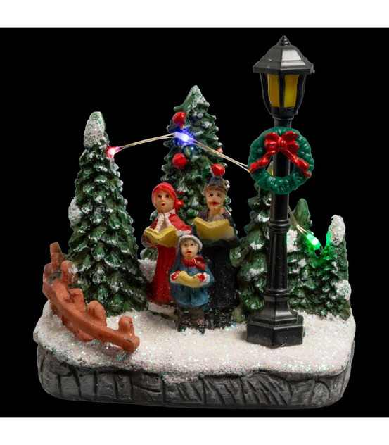 Village de noël lumineux scène de vie avec personnages et sapins