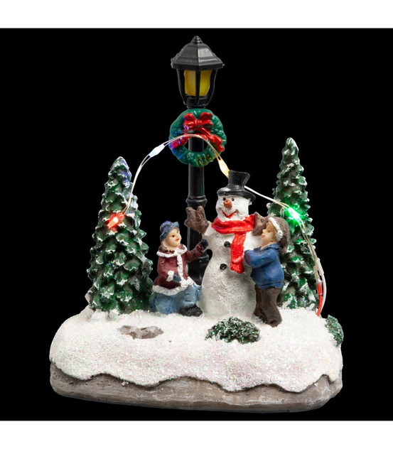 Village de noël lumineux scène de vie avec personnages et sapins