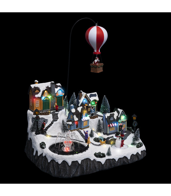 Village de noël lumineux, animé et musical père noël dans sa mongolfière