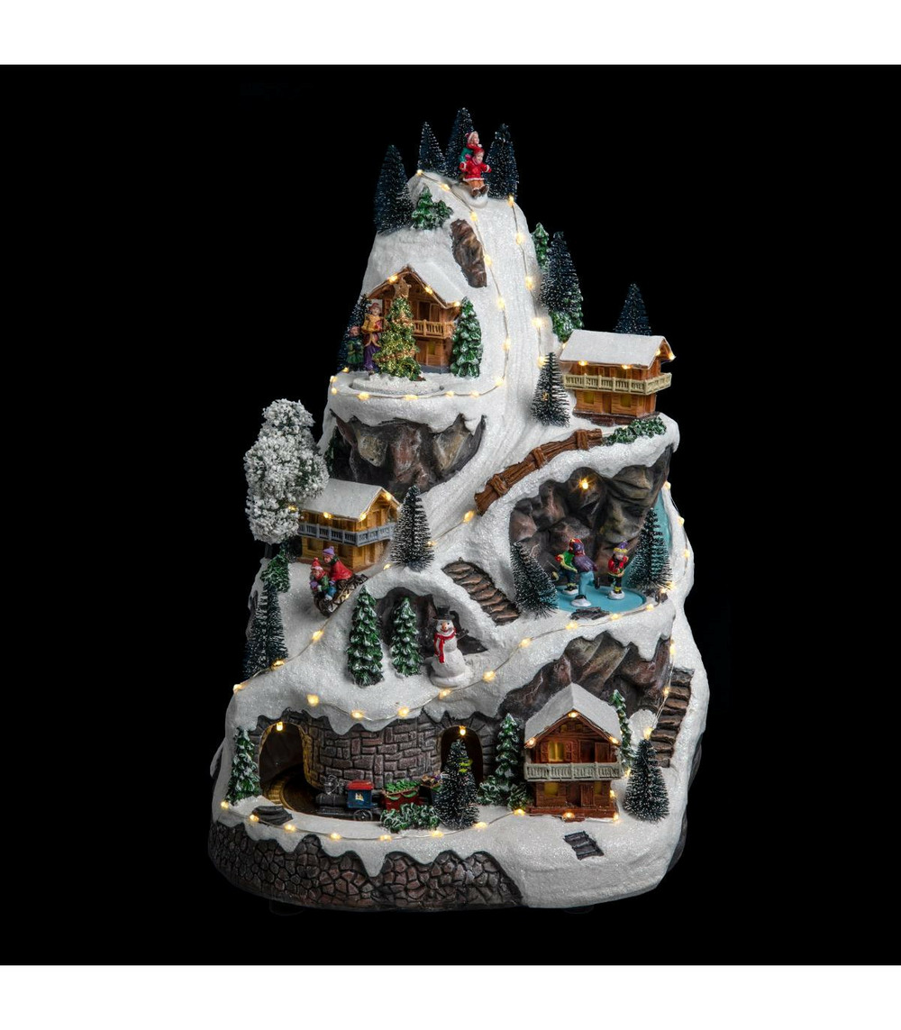 Village de noël lumineux, musical et animé montagne avec maisons et sapins enneigés