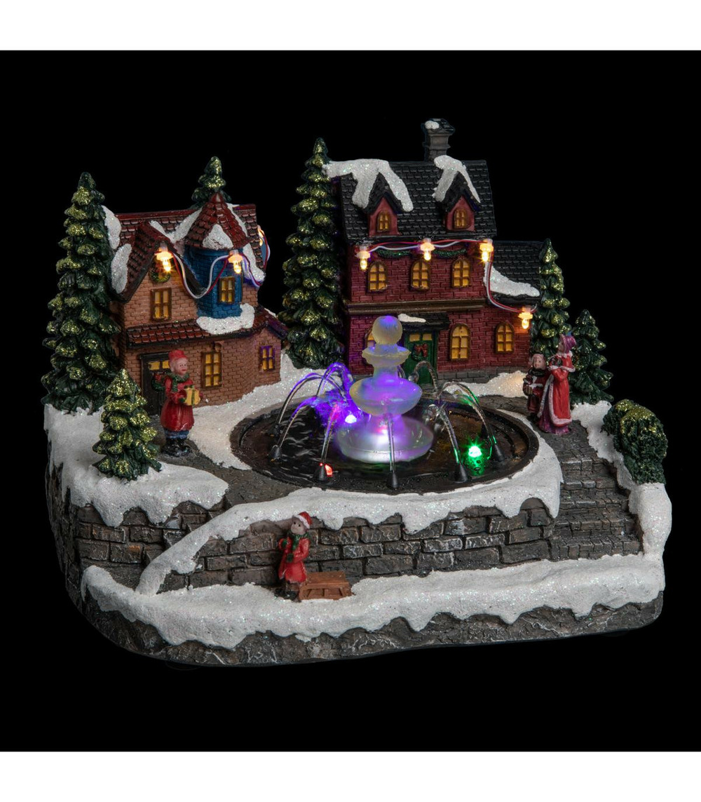 Village de noël lumineux et mouvement d'eau scène de vie autour d'une fontaine