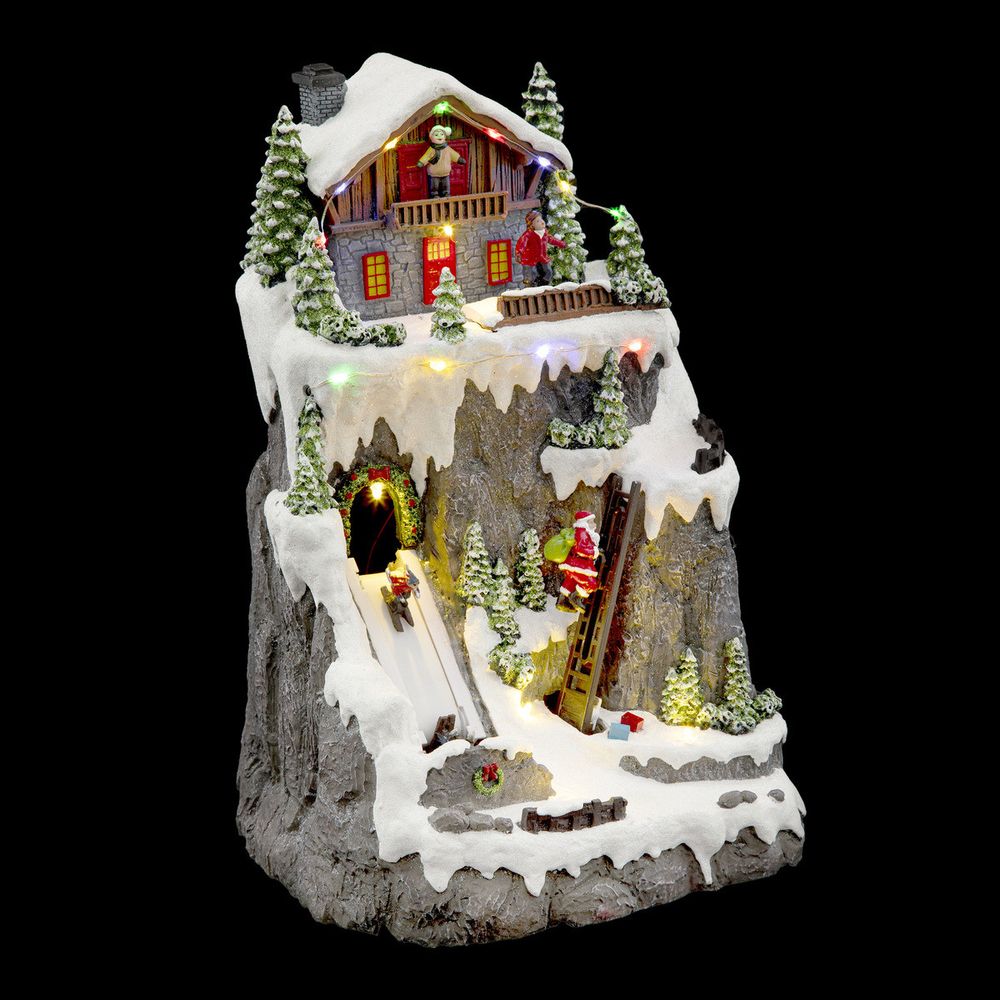 Village de noël lumineux, animé et musical chalet et père noël grimpeur