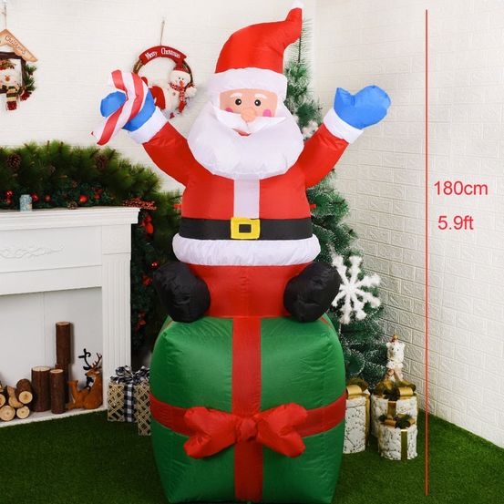 Structure de noël gonflable - père noël assis sur un cadeau