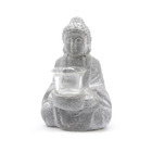 Statue de bouddha en béton avec bougeoir en verre