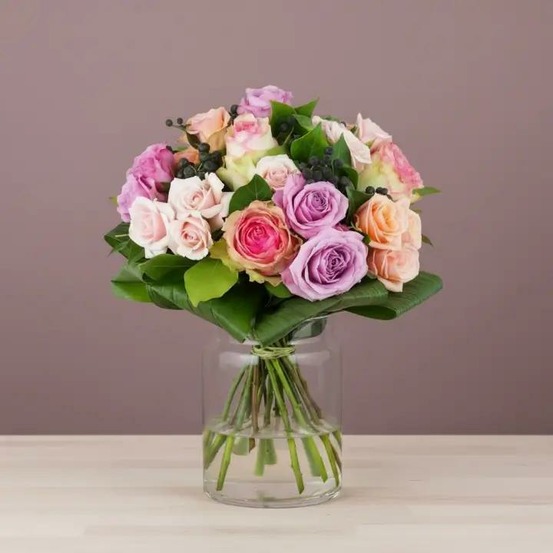Bouquet de fleurs fraîches avec des roses roses, des roses pêche et du feuillage vert