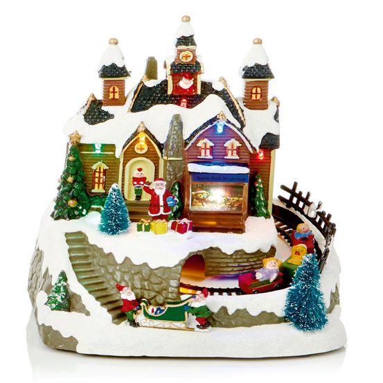 Village illuminé de noël - magasin du père noël avec ses lutins
